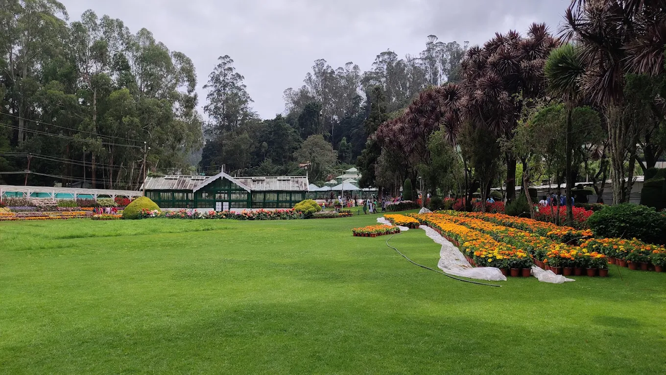 Government Botanical Garden in Ooty with terraced lawns, trees and flower beds