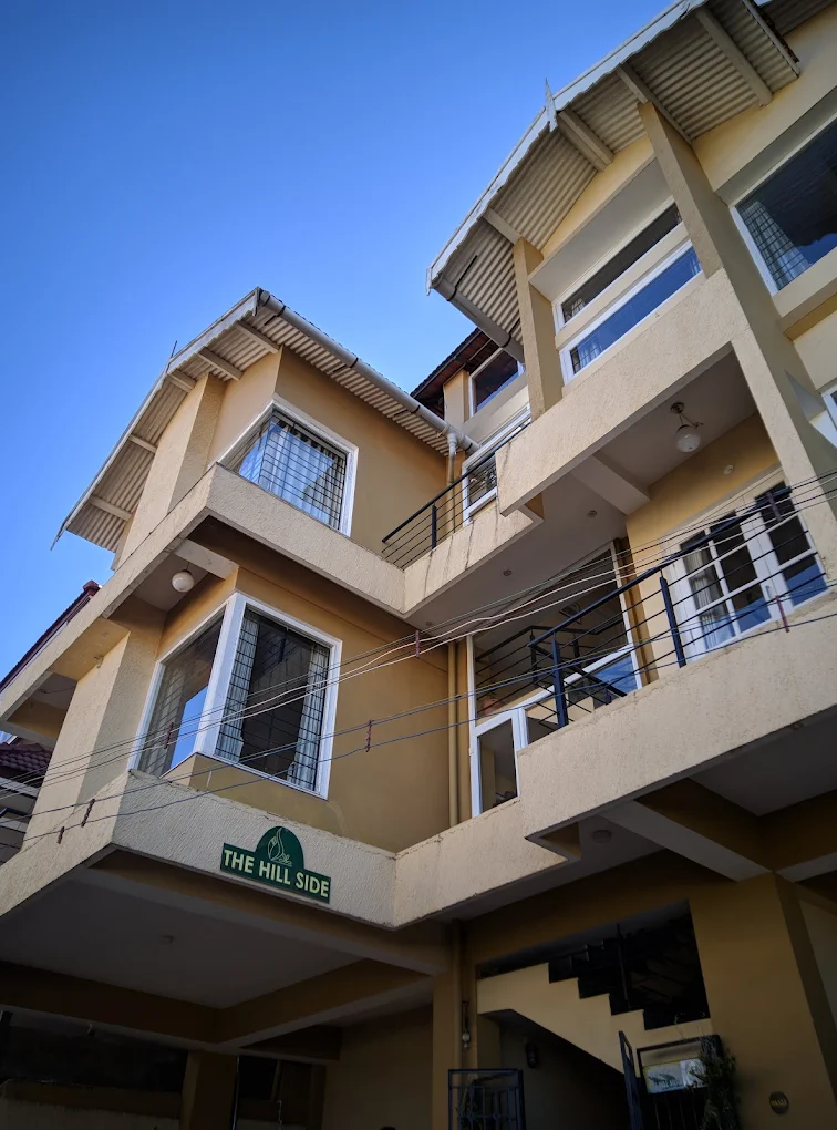Side view of Hill Side Cottage, Ooty with greenery