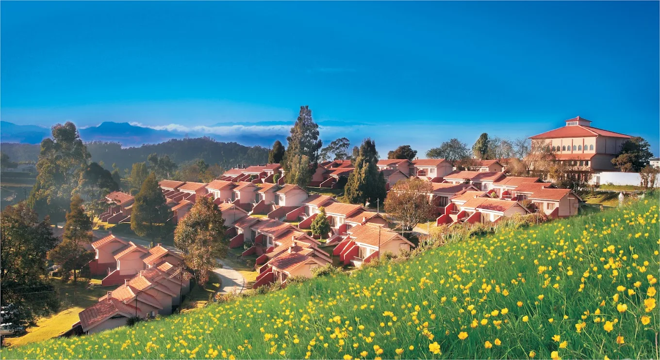 Front view of Hotel Lake View, Ooty cottages facing lawn and valley