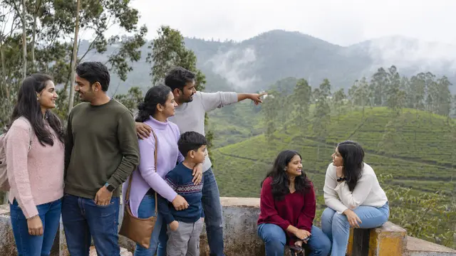 Indian couples, family and friends enjoying a Nilgiris tea estate viewpoint near Ooty