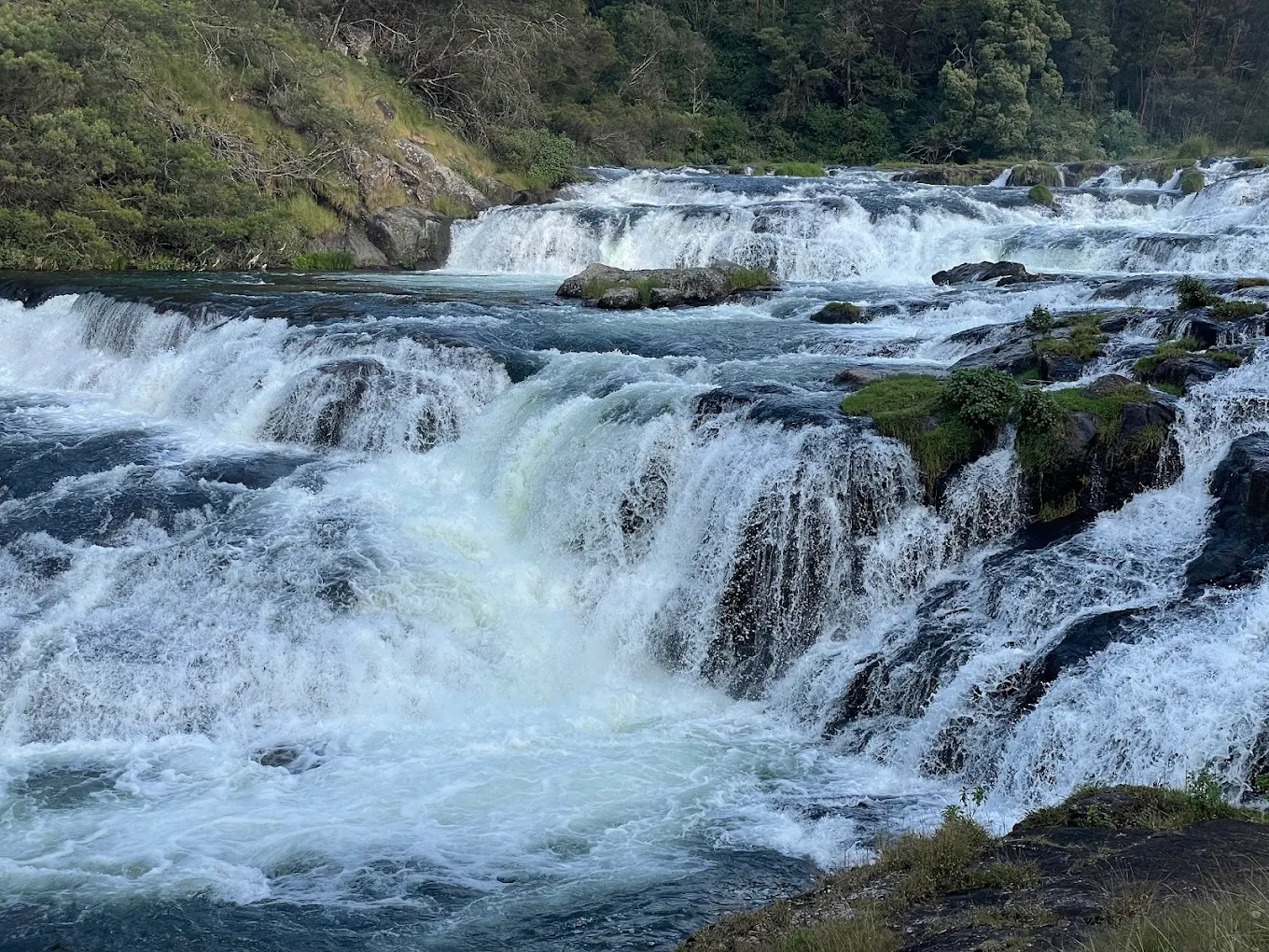 Pykara Falls near Ooty cascading over rocky steps with forested backdrop