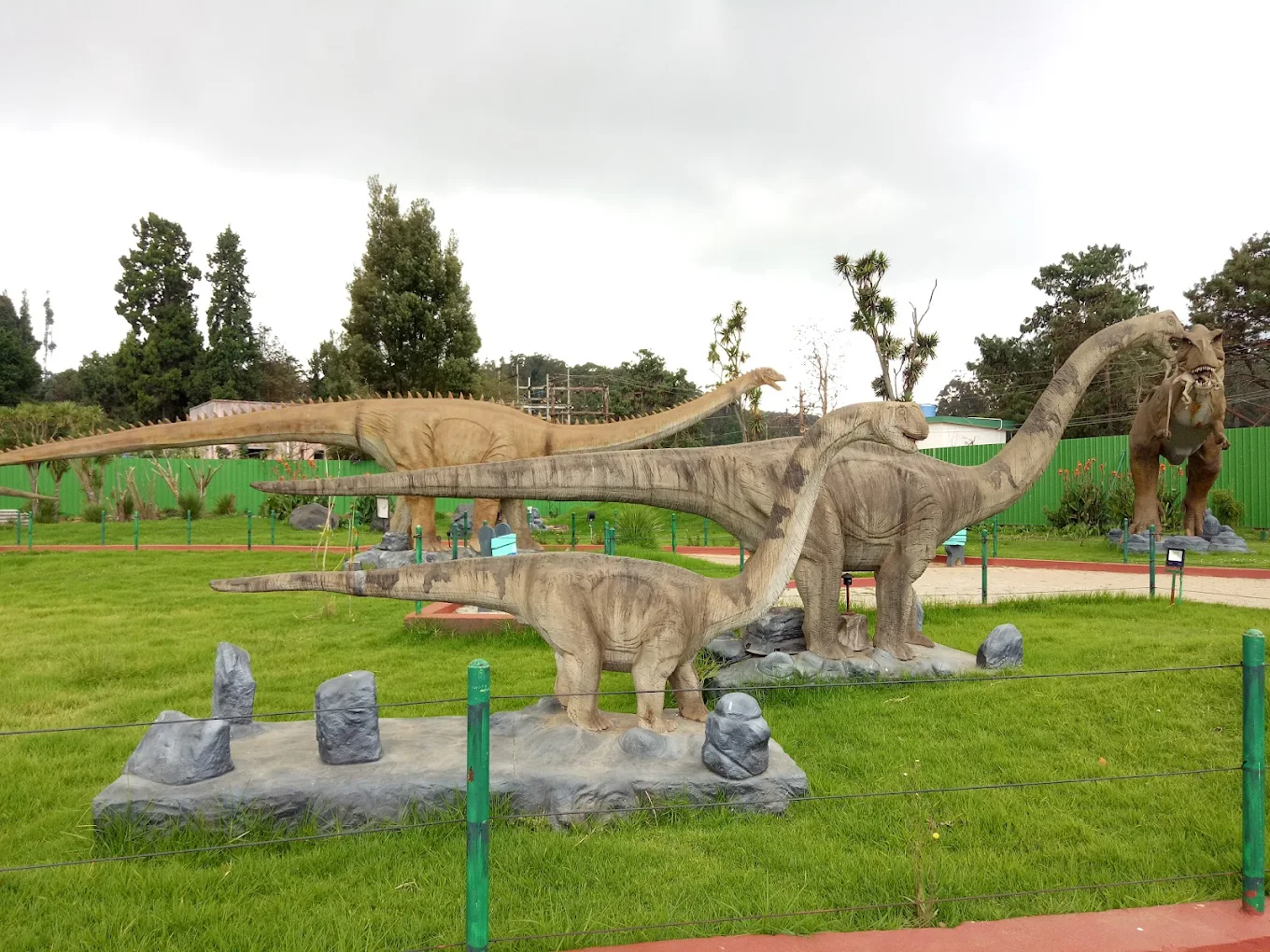 Thunder World amusement park in Ooty with dinosaur models and rides near the lake